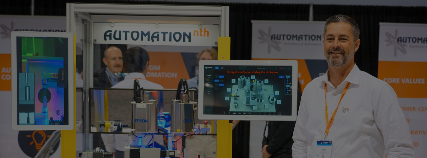 A man is positioned in front of a machine, which is currently displaying an image for him to view