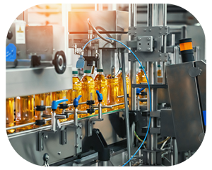 A production line in a factory where a machine is creating and packaging bottles