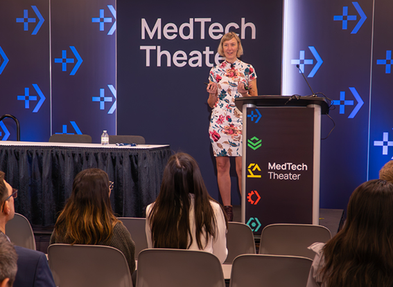 A woman confidently presenting her ideas at a professional conference, engaging the audience with her insights