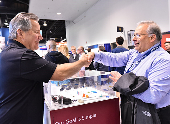 2 men are shaking hands on show floor