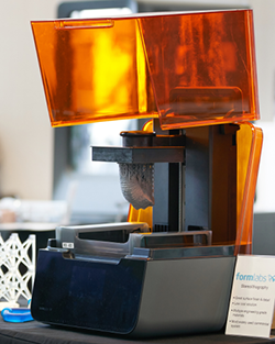 A man and woman stand together in front of a glass display case, examining the items inside