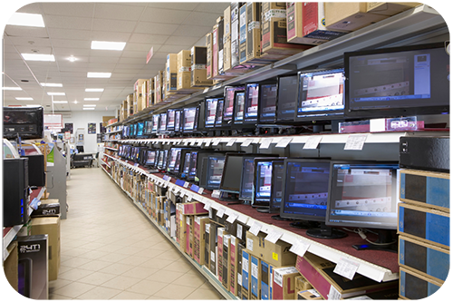 An electronics store showcasing numerous computers and monitors arranged neatly on shelves