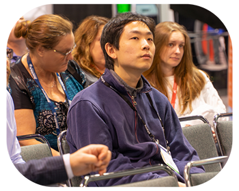 Conference attendees focuse on presentation on the stage