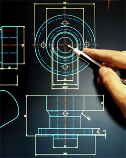 A person carefully illustrates a blueprint with a pencil, emphasizing the intricate details of the design