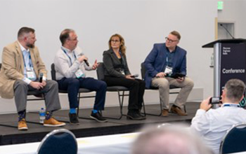 Conference speakers presenting on stage